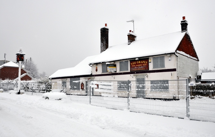 The abandoned Grapes pub, Pease Pottage, in winter