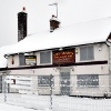 The abandoned Grapes pub, Pease Pottage, in winter