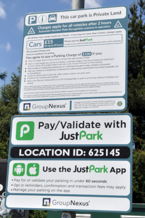 A sign containing plenty of text, including: This car park is private land, and pay-validate with Just Park